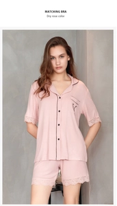 Detail of dry rose modal pajamas with contrasting black piping and delicate lace trim