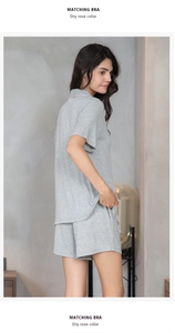 Detail of grey ribbed short sleeve pajama top with pink trim and chest pocket detail