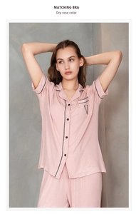 Detail of dry rose modal pajamas with black piping and letter V embroidery on the pocket