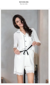 Detail of white modal pajama set with black contrast trim and delicate lace hem edges