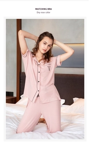 Close-up of dry rose modal pajamas with black piping and embroidered pocket detail