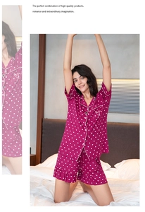 Close-up of mauve pajamas set with white heart patterns and ruffle hem shorts