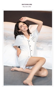 Detail of white striped nightshirt with black piping and delicate lace hem stitching