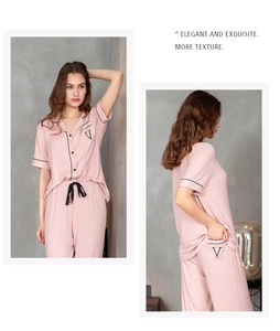 Close-up of pink striped modal pajama set with elegant black piping and 'V' embroidery