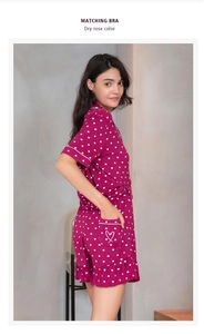 Detail of dry rose modal pajamas with white heart prints and ruffled hem shorts
