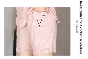 Detail of pink lounge shorts with lace hem, ribbed cotton fabric and V-letter pocket