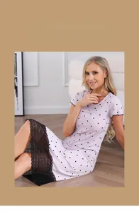 Détail de nuisette rose clair à pois avec bordure en dentelle noire élégante sur l'ourlet