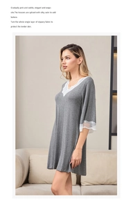 Close-up of elegant V-neckline with delicate white lace trim on modal cotton nightgown