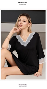 Close-up of black modal nightgown featuring delicate white lace trim and deep V-neckline