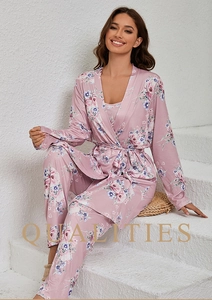 Detail of pink floral satin pajama set featuring a tie-waist robe and matching trousers