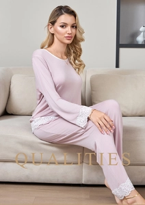 Detailed view of white lace trim on cuffs and hem of mauve modal pajama set