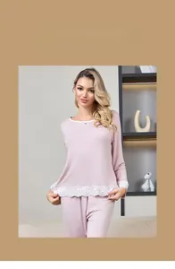 Close-up of elegant white lace trim on a pink modal cotton pajama set for women
