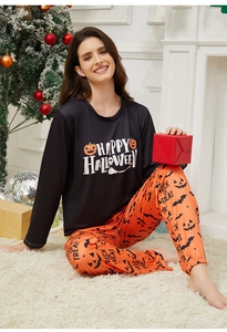 Close-up of Halloween pajama set with Happy Halloween print and festive pumpkin patterns