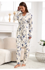 Three-piece floral knit pajamas set featuring a robe, camisole, and pants in creamy white