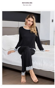 Detailed view of elegant white lace trim on sleeve cuffs of a black modal cotton pajama set