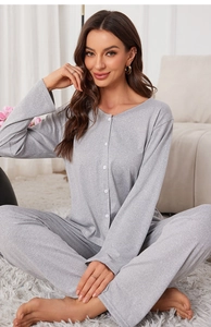 Detail of grey knitted cotton pajamas set featuring soft fabric texture and buttoned neck