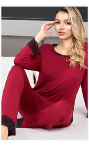 Close-up of elegant black lace trim on sleeve cuffs of burgundy modal pajama set