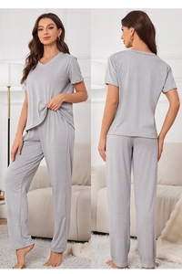 Front and back view of a soft grey two-piece knitted cotton pajamas set in a home setting