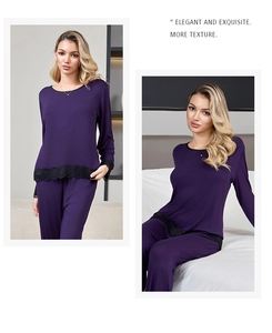 Detail of dark purple modal pajamas featuring intricate black lace trim on the cuffs and hem