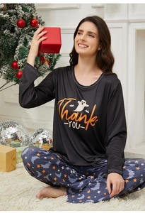 Detail view of women's Halloween pajama set with ghost print and star pattern pants