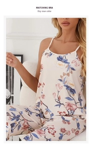 Close-up of cotton pajama set in dry rose floral pattern on a cozy plush sofa