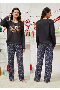 Ghost print loungewear set featuring orange stars and bat patterns on pants and top