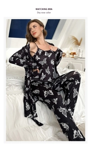 Three-piece black pajamas set with white butterfly print featuring cami, robe, and pants