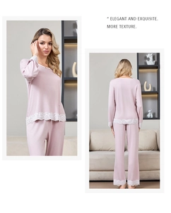 Close-up detail of soft pink modal pajamas with delicate white lace trim on sleeves
