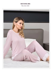 Detail of dry rose modal pajamas featuring elegant white lace trim on sleeves and hemline