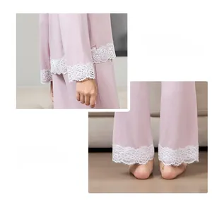 Detail view of pink modal pajamas featuring vintage white lace cuffs and hems