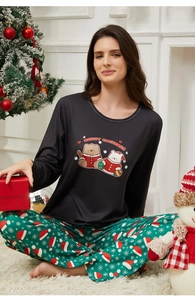 Close-up of women's Christmas pajama set with festive bear print and snowflake pants