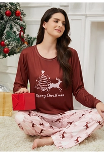 Close-up of Christmas pajamas featuring Merry Christmas print with reindeer and tree