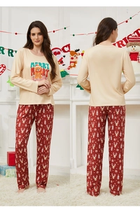 Detail of Christmas pajama set featuring beige bear top and red deer print pants