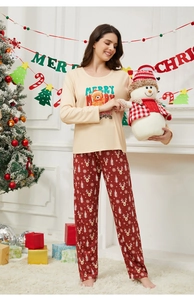 Detail of Christmas pajamas featuring a Merry Christmas bear print and reindeer pants