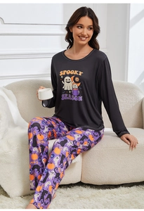Cozy lifestyle view of a women's Halloween pajama set with spooky season graphic print