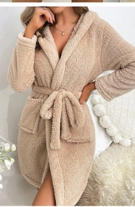 Detail of soft beige plush bathrobe showing thick coral fleece texture and belted waist