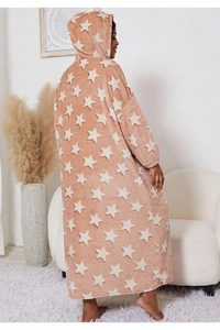 Detail of pink flannel blanket hoodie with white star patterns and a soft plush texture
