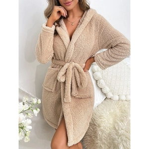 Women's warm plush fleece bathrobe with belted waist and pockets in a cozy home setting