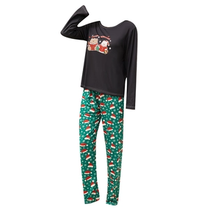 Women's Christmas pajama set featuring black Merry Christmas top and green festive pants