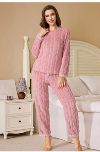 Detail of pink coral fleece pajamas set with cable knit pattern and lace trim