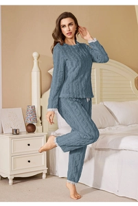 Detail of grey-blue coral fleece pajamas showing thick cable knit texture and lace trim