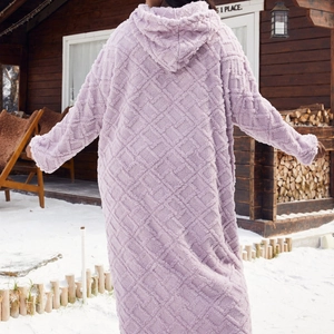 Women's cozy purple hooded plush bathrobe with diamond pattern in a winter outdoor setting