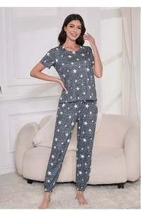 Detail view of women's grey pajama set with white star print and ribbed cuffs