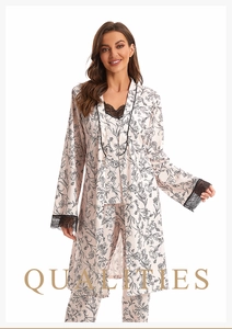 Detail view of pink floral print 3-piece pajama set with lace trim and satin texture