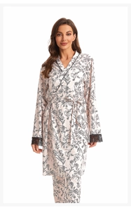 Detailed view of pink floral pajama robe with black lace cuffs and matching trousers
