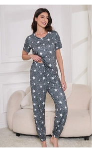 Detail of star pattern women's pajama set featuring short sleeves and elastic long pants