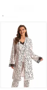 Detail of pink 3-piece floral sleepwear set with black lace trim and botanical prints