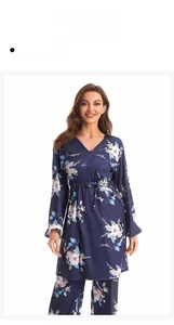 Detail of dark blue floral pajama set featuring long sleeves and waist drawstring ties
