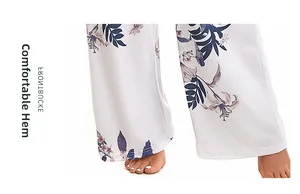 Close-up of comfortable flat hemming on white floral print pajama pants with purple flowers