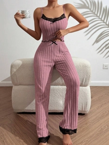 Detailed view of pink ribbed lounge set featuring black lace trim and bow accents